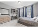 Bedroom with a gray color scheme, large window with blue curtains, and study and dresser at 13245 E 131St St, Fishers, IN 46037