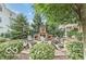 Outdoor fire pit area with seating, surrounded by lush greenery, perfect for gatherings and relaxation at 13245 E 131St St, Fishers, IN 46037