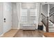 Bright foyer with natural light, hardwood floors, and staircase access to the upper level at 13245 E 131St St, Fishers, IN 46037