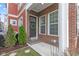 Inviting front porch featuring brick accents and a decorative wreath on the front door at 13245 E 131St St, Fishers, IN 46037