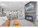 Open concept living room with a fireplace, TV, and seamless flow to the kitchen at 13245 E 131St St, Fishers, IN 46037