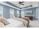 Inviting main bedroom features tray ceiling, ceiling fan, and large windows offering ample natural light and privacy at 13245 E 131St St, Fishers, IN 46037