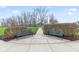 Inviting park benches along a walking path lined with manicured bushes and mature trees at 13245 E 131St St, Fishers, IN 46037