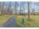 Scenic park path leading to a covered shelter with picnic tables, surrounded by mature trees at 13245 E 131St St, Fishers, IN 46037