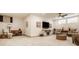 Finished basement with neutral carpet, ceiling fan, furnishings, and bright lighting at 1395 Chatham Hills Blvd, Westfield, IN 46074