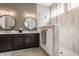 Modern bathroom featuring double vanity sinks, decorative mirrors, and luxurious walk-in shower at 1395 Chatham Hills Blvd, Westfield, IN 46074