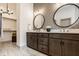 Modern bathroom featuring double vanity sinks, decorative mirrors, and luxurious walk-in closet at 1395 Chatham Hills Blvd, Westfield, IN 46074