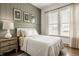 Bright bedroom featuring paneled accent wall, three windows, white comforter and hardwood floors at 1395 Chatham Hills Blvd, Westfield, IN 46074