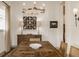 Bright dining room features a wooden table, modern chandelier and elegant decor at 1395 Chatham Hills Blvd, Westfield, IN 46074
