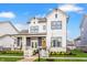 Charming two-story home with white siding, black trim, inviting front porch, and manicured landscaping at 1395 Chatham Hills Blvd, Westfield, IN 46074