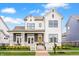Charming two-story home with white siding, black trim, inviting front porch, and manicured landscaping at 1395 Chatham Hills Blvd, Westfield, IN 46074