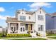 Beautiful two-story home with white siding, black trim, inviting front porch, and yellow flower landscaping at 1395 Chatham Hills Blvd, Westfield, IN 46074