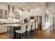 Modern kitchen featuring white cabinetry, stainless steel appliances, a dark island, and stylish pendant lighting at 1395 Chatham Hills Blvd, Westfield, IN 46074