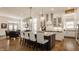 Open-concept kitchen boasts a center island, granite counters, pendant lighting, and seamless flow to the living area at 1395 Chatham Hills Blvd, Westfield, IN 46074
