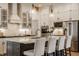 Modern kitchen featuring white cabinetry, stainless steel appliances, a dark island, and stylish pendant lighting at 1395 Chatham Hills Blvd, Westfield, IN 46074