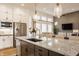 Spacious kitchen island with bar seating, stainless appliances, granite countertops, and pendant lighting at 1395 Chatham Hills Blvd, Westfield, IN 46074