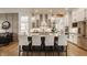 Modern kitchen featuring white cabinetry, stainless steel appliances, a dark island, and stylish pendant lighting at 1395 Chatham Hills Blvd, Westfield, IN 46074