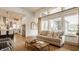 Bright and airy living room featuring large windows and open floor plan to the kitchen at 1395 Chatham Hills Blvd, Westfield, IN 46074