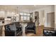 Open-concept living room with hardwood floors, neutral wall colors, and seamless access to the modern kitchen at 1395 Chatham Hills Blvd, Westfield, IN 46074
