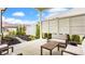 Covered patio featuring comfortable seating and a landscaped yard with a stone path at 1395 Chatham Hills Blvd, Westfield, IN 46074
