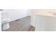 Bathroom featuring new toilet, modern faucet, new vanity, and luxury vinyl plank flooring at 1403 Lafayette Ave, Columbus, IN 47201
