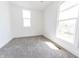 Bright bedroom featuring neutral carpet, white walls, two windows offering ample natural light and sunlight at 1403 Lafayette Ave, Columbus, IN 47201