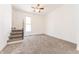 Bright bedroom with a staircase, window, and neutral carpeting at 1403 Lafayette Ave, Columbus, IN 47201