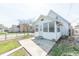 Exterior of a two-story home featuring a cozy, enclosed sunroom with ample natural light at 1403 Lafayette Ave, Columbus, IN 47201