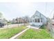 Exterior of a two-story home featuring a cozy, enclosed sunroom and a well-maintained lawn at 1403 Lafayette Ave, Columbus, IN 47201