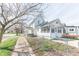Charming two-story home with a fenced yard, sidewalk, and inviting front porch at 1403 Lafayette Ave, Columbus, IN 47201