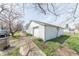 View of a two-car detached garage showing a white exterior with an alleyway behind the home at 1403 Lafayette Ave, Columbus, IN 47201