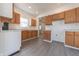 Bright kitchen featuring light wood cabinets, white counters, and gray laminate floors at 1403 Lafayette Ave, Columbus, IN 47201