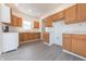 Modern kitchen with light wood cabinets, white countertop, and gray laminate flooring at 1403 Lafayette Ave, Columbus, IN 47201