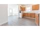 Well-lit kitchen featuring light wood cabinets, white counters, and gray laminate floors at 1403 Lafayette Ave, Columbus, IN 47201