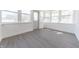 Bright sunroom with plenty of windows and gray laminate flooring at 1403 Lafayette Ave, Columbus, IN 47201