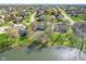 Beautiful aerial view of homes near the lake, showcasing mature trees and manicured green lawns at 14720 Warner Trl, Westfield, IN 46074