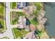 Top-down aerial view of a home next to a lake, surrounded by mature trees and greenery at 14720 Warner Trl, Westfield, IN 46074