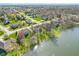 Serene aerial view of lakeside homes, featuring mature trees and lush greenery in a beautiful neighborhood at 14720 Warner Trl, Westfield, IN 46074