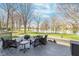 Inviting backyard deck with seating, firepit, and serene waterfront view at 14720 Warner Trl, Westfield, IN 46074