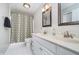 Bright bathroom featuring double sinks, a shower-tub, and white tiled floors at 14720 Warner Trl, Westfield, IN 46074