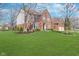 Beautiful two-story brick home with a lush green lawn and mature trees, offering a serene and inviting curb appeal at 14720 Warner Trl, Westfield, IN 46074