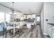 Modern kitchen features white cabinetry, stainless steel appliances, and an adjacent breakfast area at 14720 Warner Trl, Westfield, IN 46074