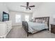 Spacious main bedroom with carpet floors, a ceiling fan, a large bed and bright, light-filled windows at 14720 Warner Trl, Westfield, IN 46074