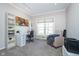 Bright office space features a large window, desk, bookshelves, and comfortable seating at 14720 Warner Trl, Westfield, IN 46074
