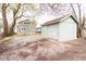 Backyard view of home, detached garage and shared gravel driveway at 1515 Dawson St, Indianapolis, IN 46203