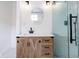 Modern bathroom featuring a glass enclosed shower, wood vanity, and updated fixtures at 1515 Dawson St, Indianapolis, IN 46203