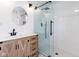 Modern bathroom featuring a glass enclosed shower, wood vanity, and updated fixtures at 1515 Dawson St, Indianapolis, IN 46203