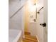 A well-lit, modern bathroom featuring updated fixtures, wood floors and white tiling at 1515 Dawson St, Indianapolis, IN 46203