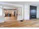 Open-concept living space with wood floors, leading into a modern kitchen with an island and stainless appliances at 1515 Dawson St, Indianapolis, IN 46203