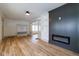 Spacious living room with stylish wood floors, built-in shelving, and a cozy electric fireplace at 1515 Dawson St, Indianapolis, IN 46203